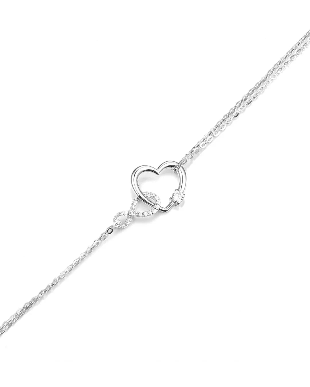 Silver heart-shaped pendant on a chain against a white background