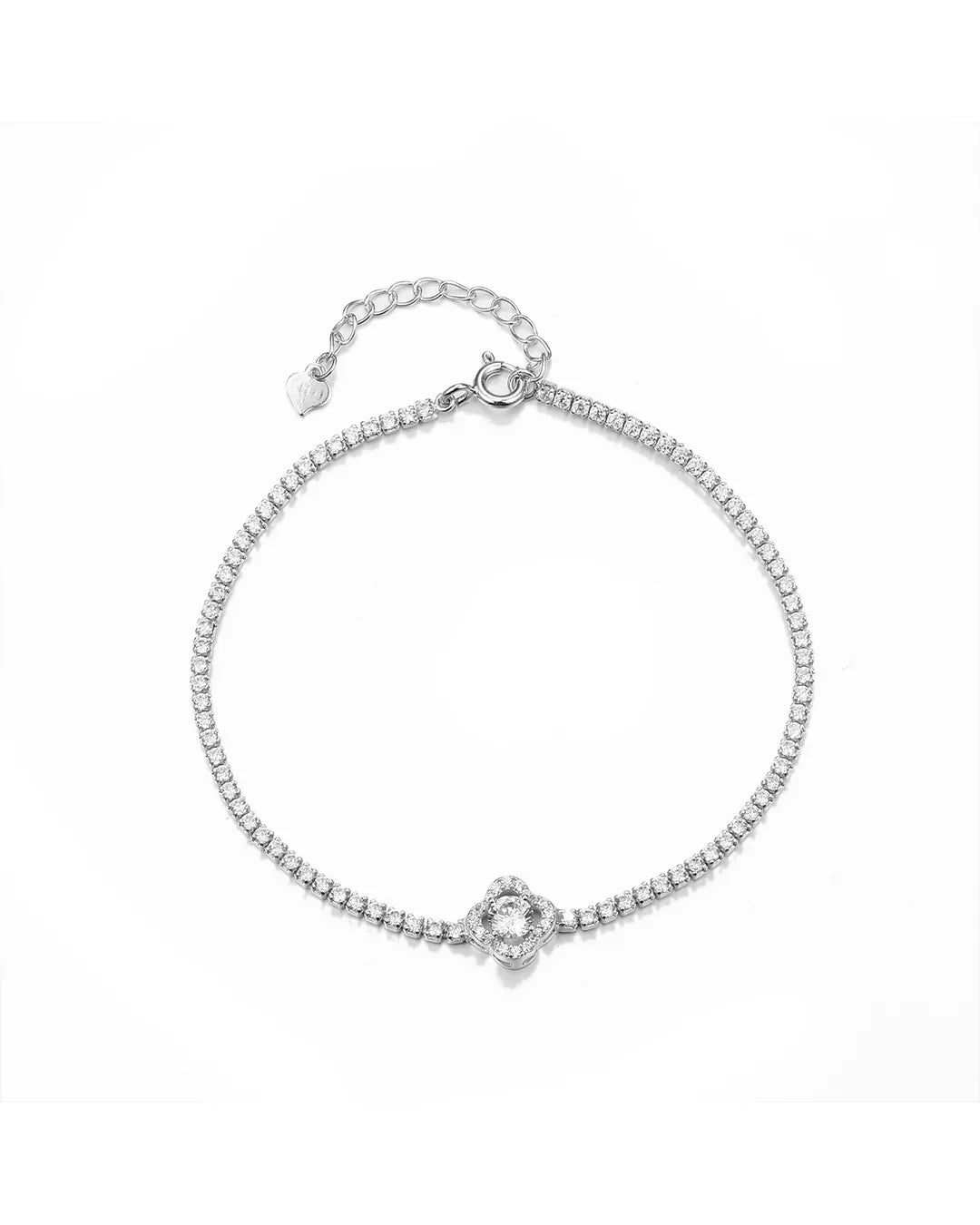 Silver bracelet with a small heart charm on a white background