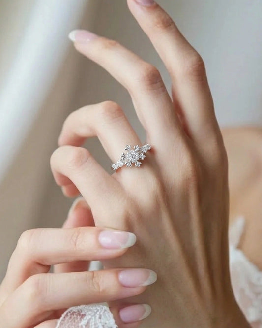Close-up of a hand wearing a diamond ring with a blurred background