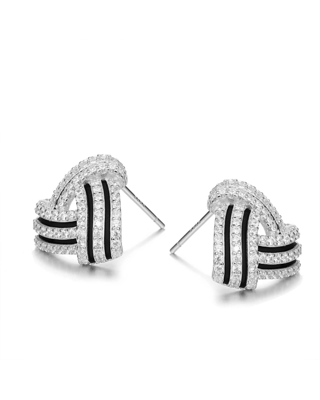 Pair of earrings with black and white design on a white background