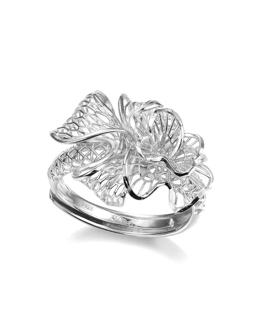 Silver ring with floral design on a white background