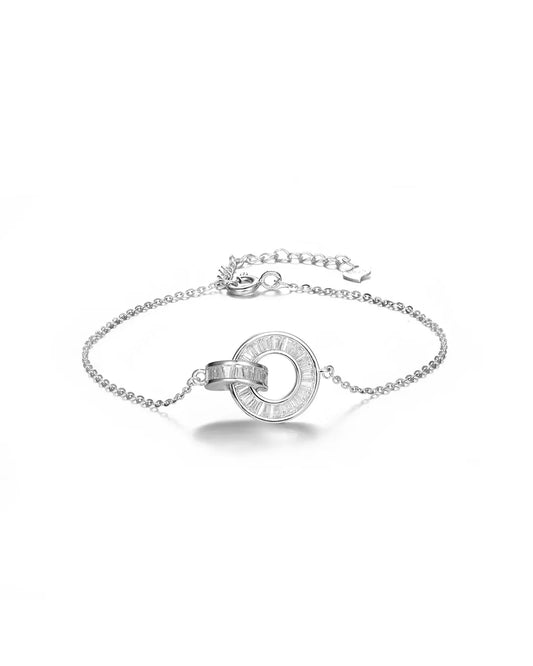 Silver bracelet with a circular design on a white background