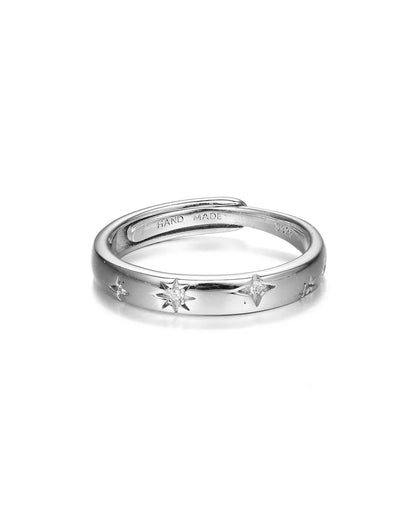 Silver ring with star designs on a white background