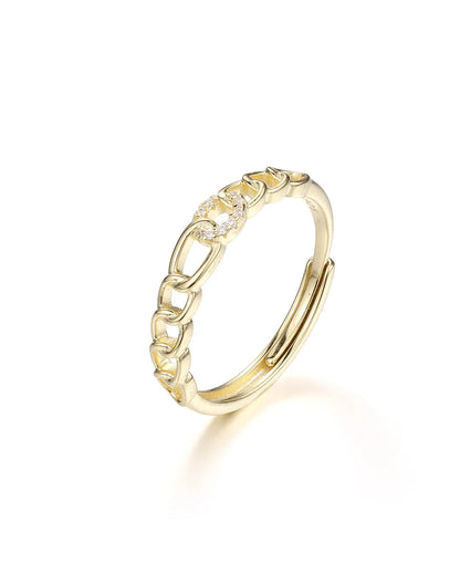 Gold ring with diamond accents on a white background