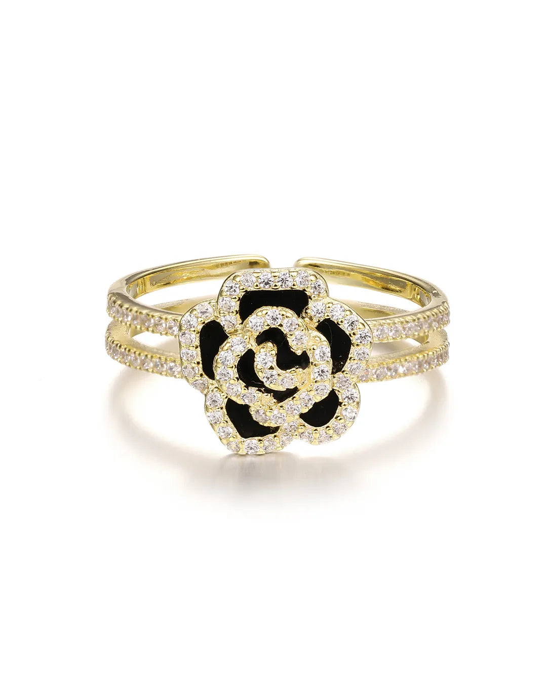 Gold bracelet with a black and white flower design on a white background