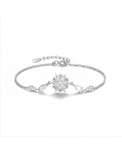 Silver bracelet with a snowflake design on a white background