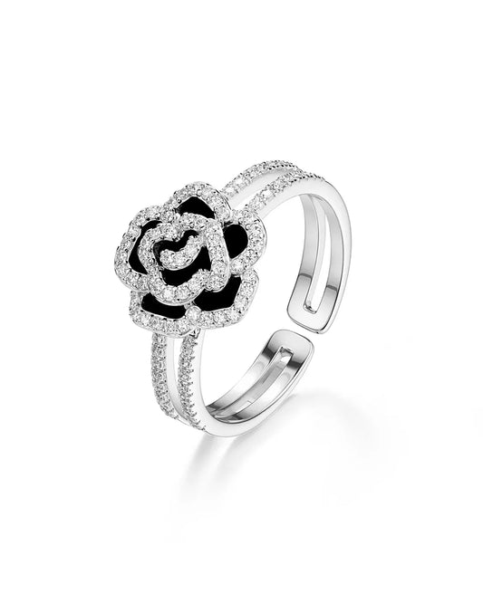 Silver open ring with heart design and small stones on a white background