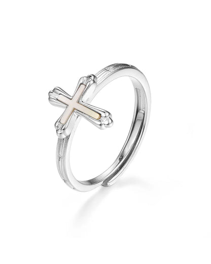 Silver ring with a cross design on a white background