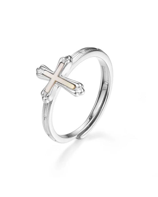 Silver ring with a cross design on a white background
