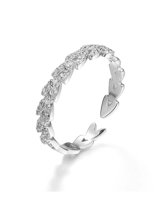 Silver ring with a wavy design on a white background