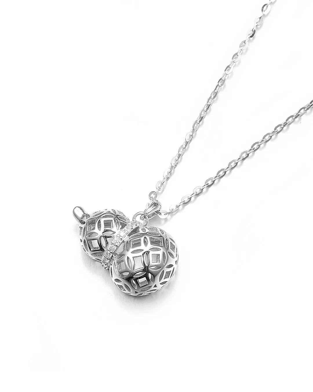 Silver necklace with two interlocking heart pendants on a white background