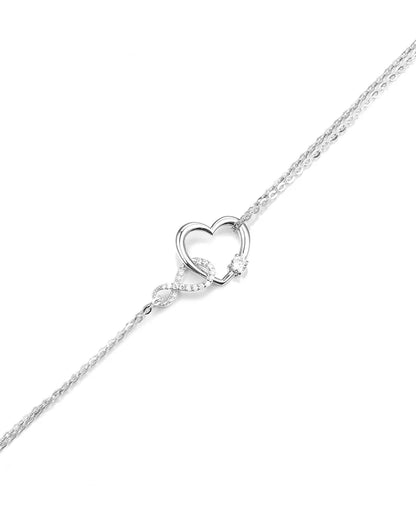 Silver heart-shaped pendant on a chain against a white background