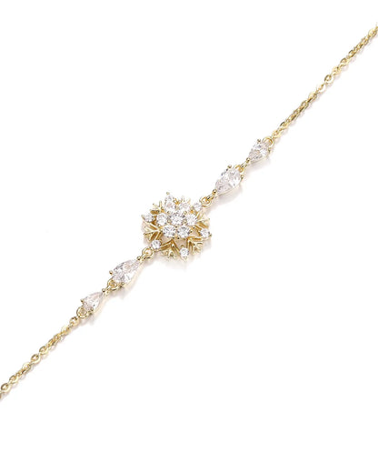 Delicate gold necklace with a floral pendant on a white background