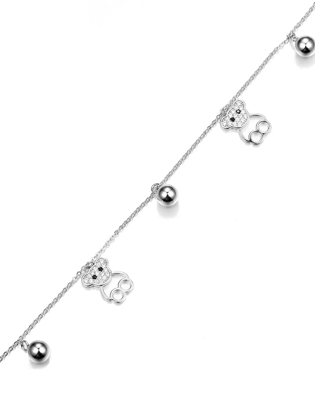 Silver necklace with small silver balls and flower-like pendants on a white background