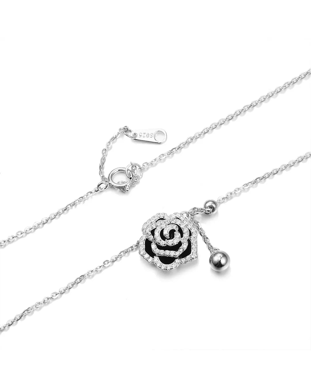 Silver necklace with a rose-shaped pendant on a white background