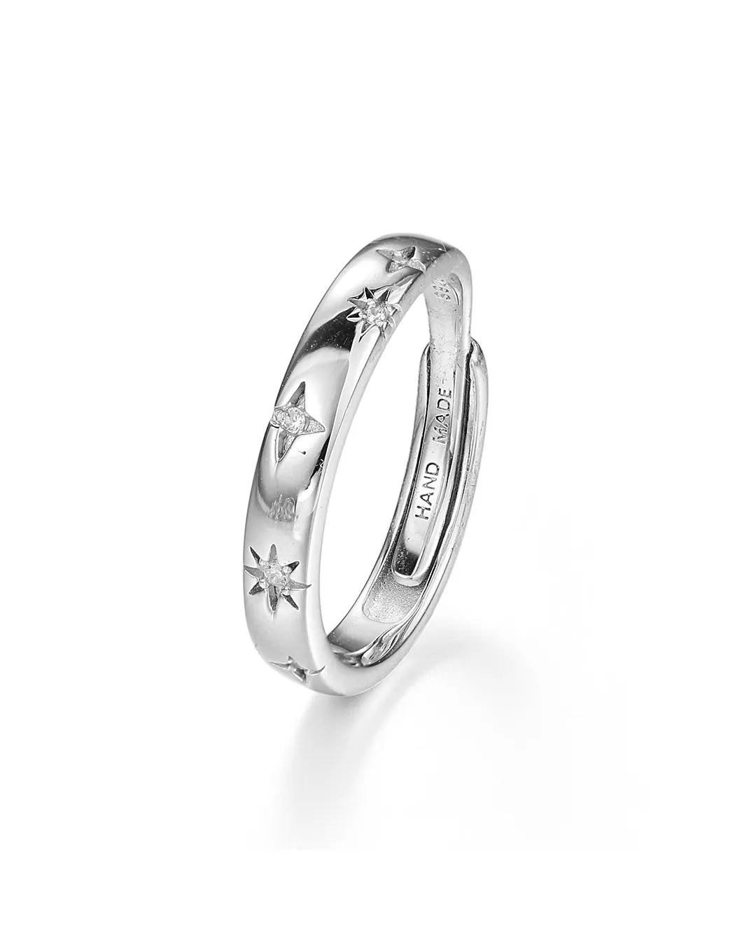 Silver ring with star designs on a white background