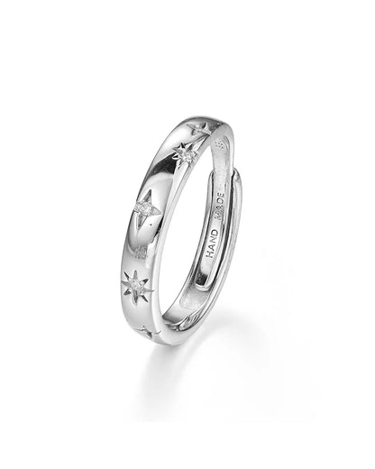 Silver ring with star designs on a white background
