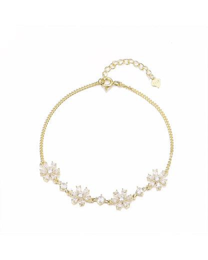 Gold necklace with floral design on a white background