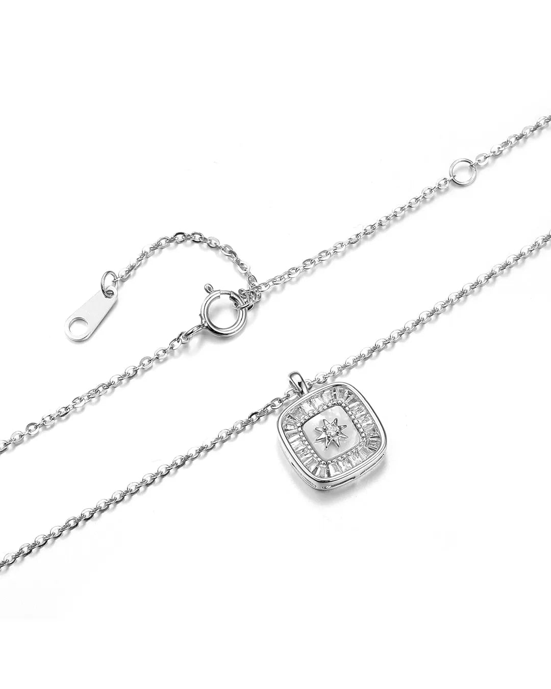 Silver necklace with a square pendant on a white background