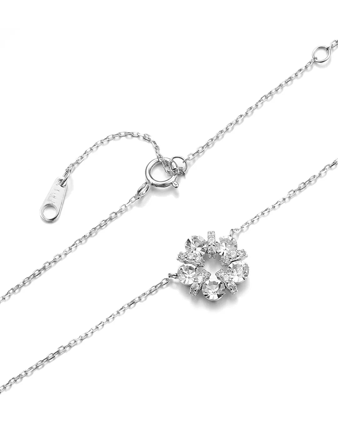 Silver necklace with a snowflake-shaped pendant on a white background