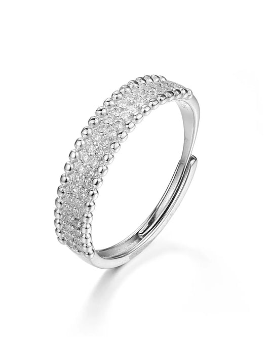 Silver ring with a textured band on a white background