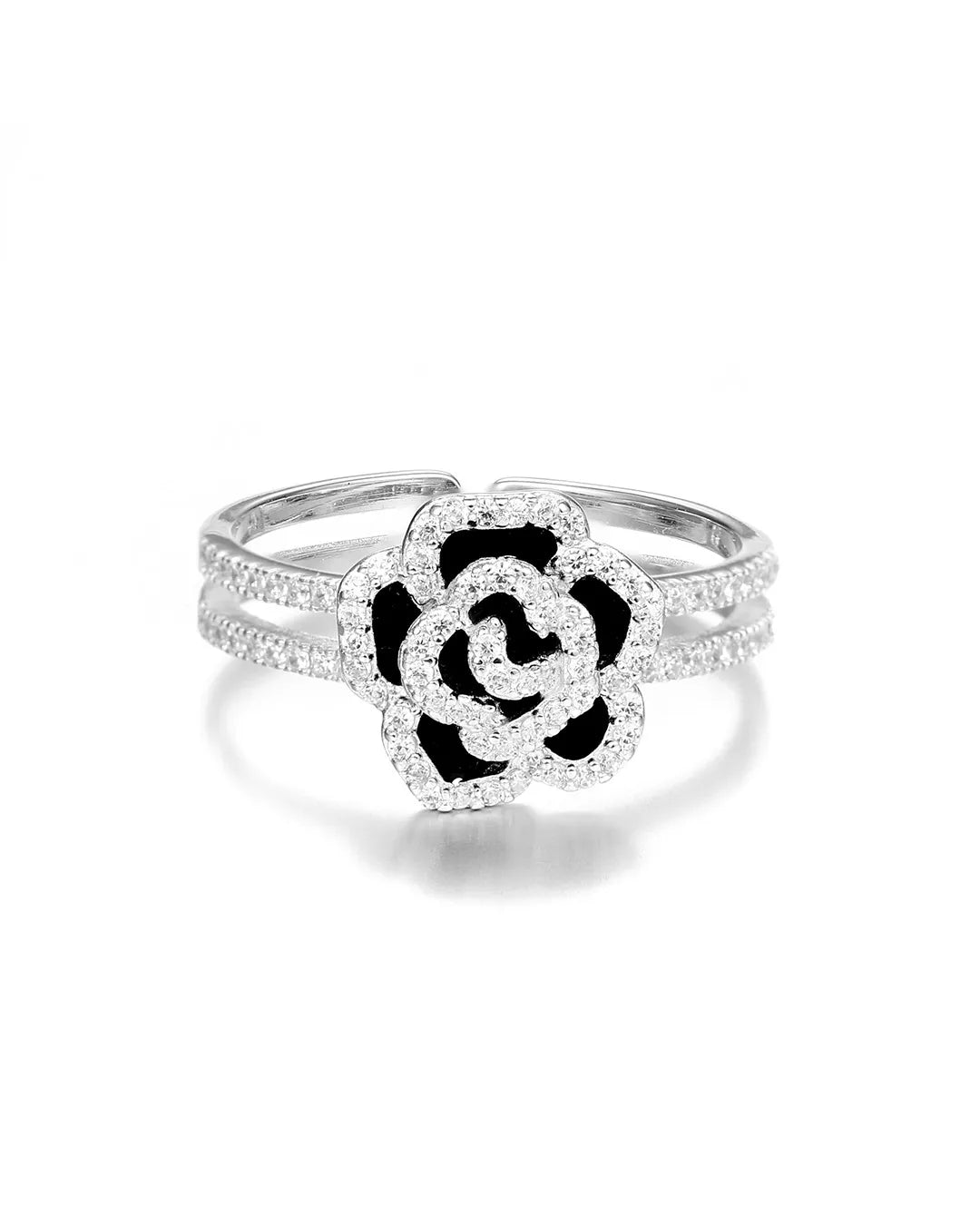 Silver ring with a black and white floral design on a white background