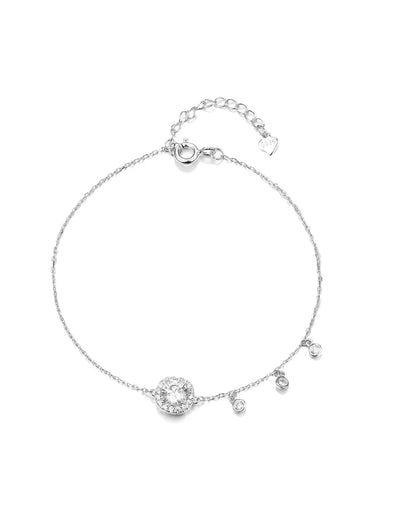 Silver bracelet with small round charm on a white background