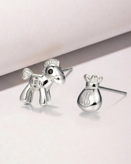 Silver horse-shaped earrings on a light background