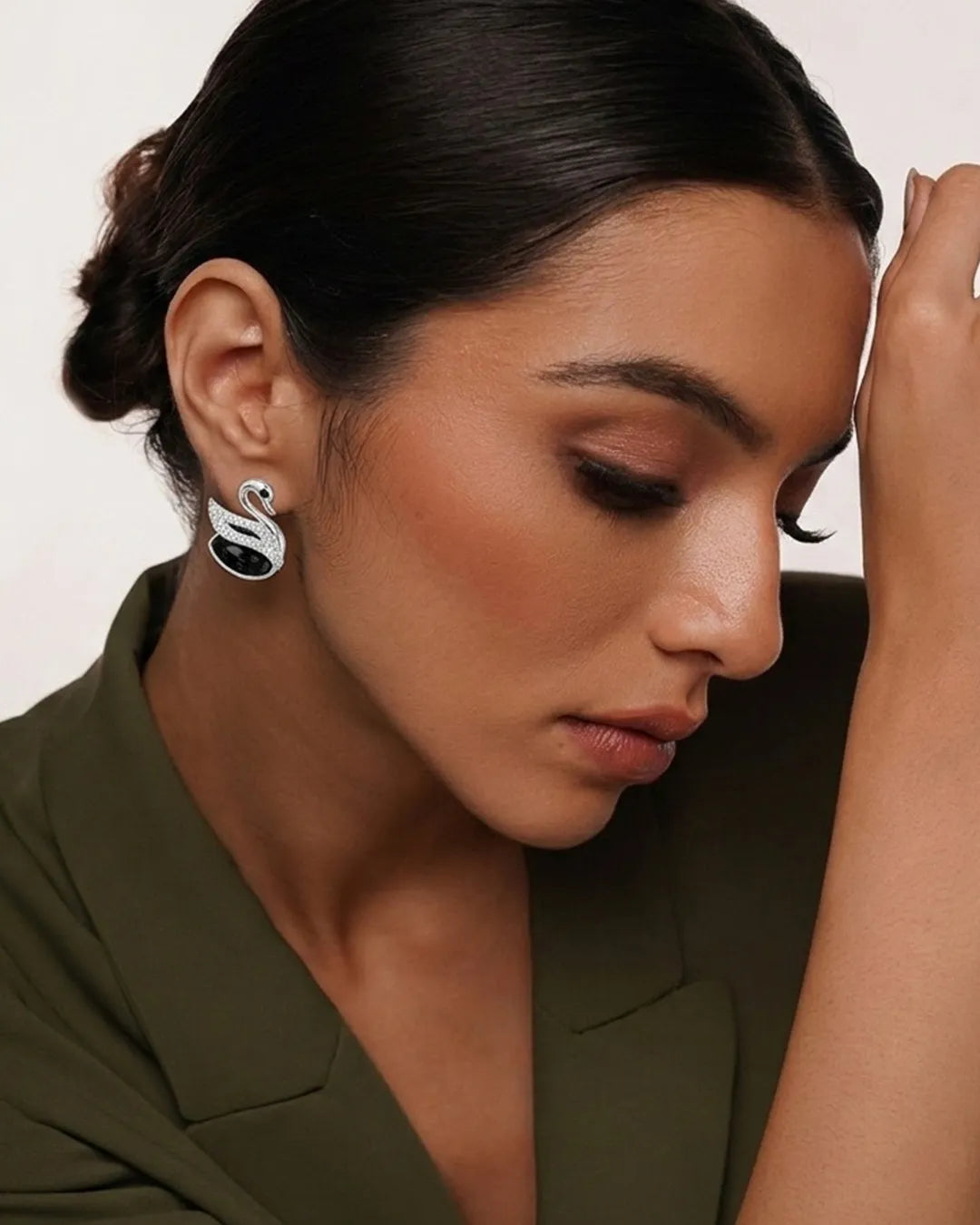 Close-up of a woman wearing a silver earring with a black gemstone.